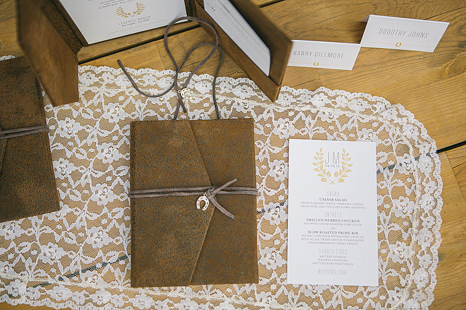 rustic barn wedding invitations with leather pocket and horseshoe charm